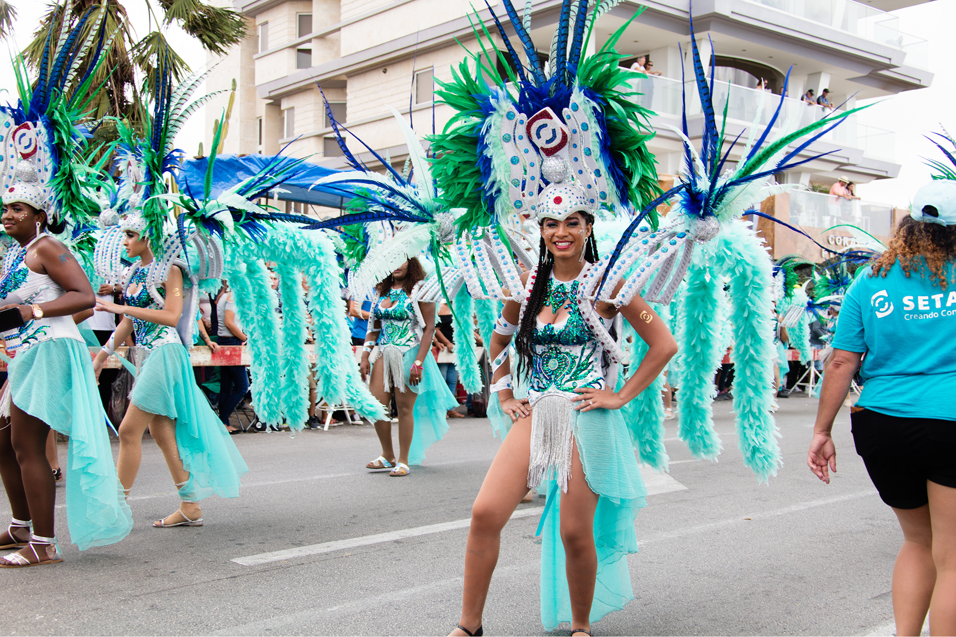 Dancers in vibrant costumes at street parade.
