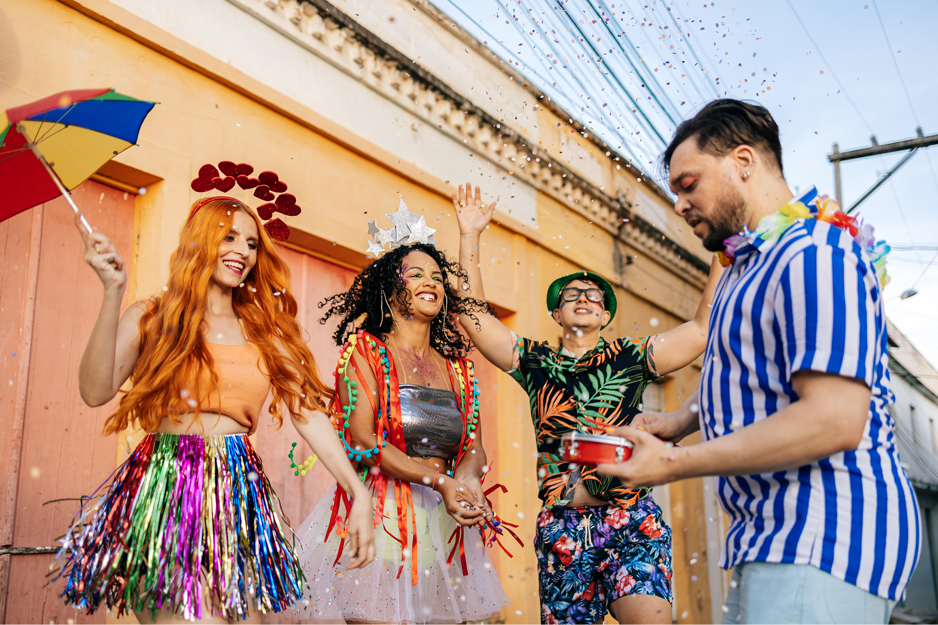 People celebrating with colorful outfits and confetti.